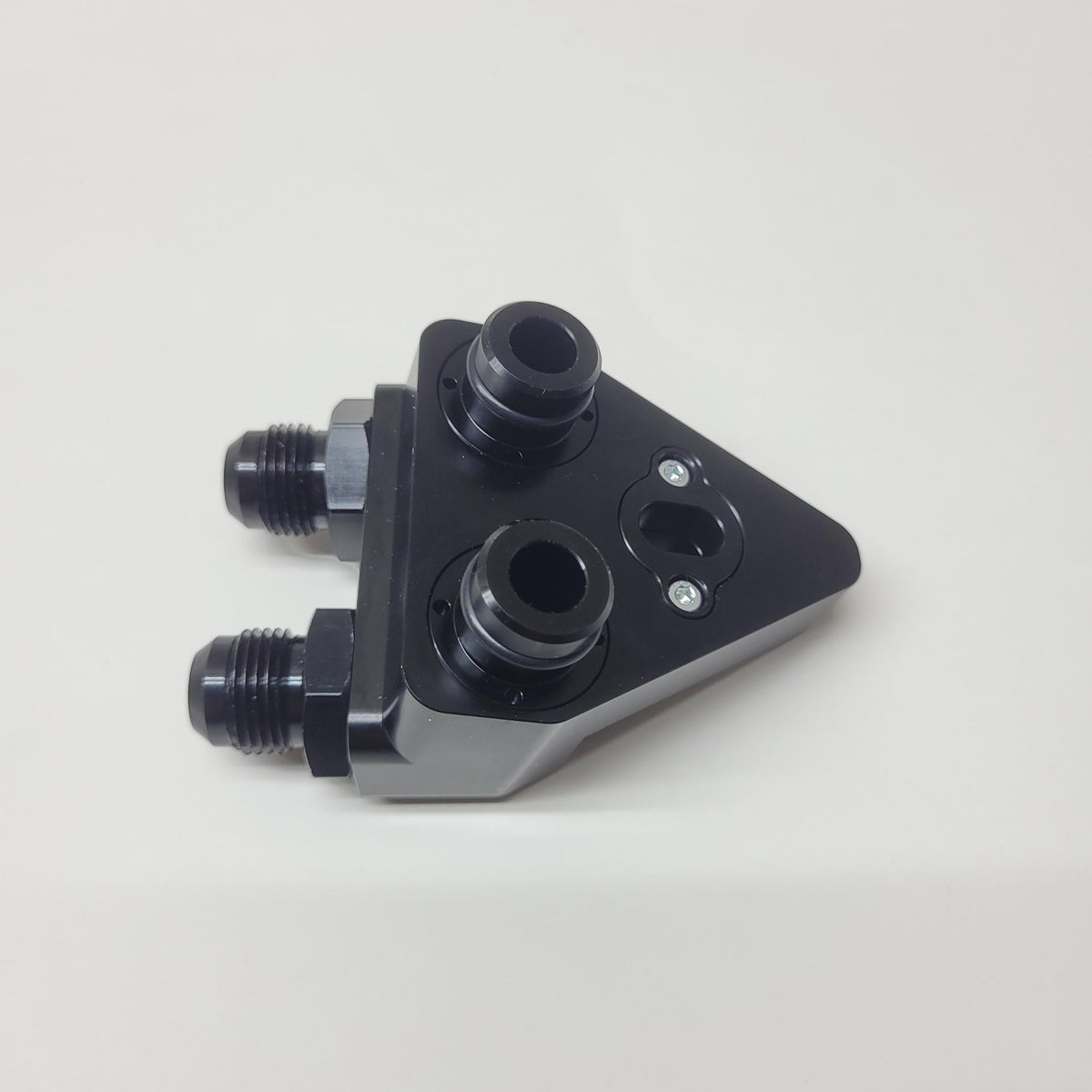 Cooler adapter underside with interchangeable port fittings installed